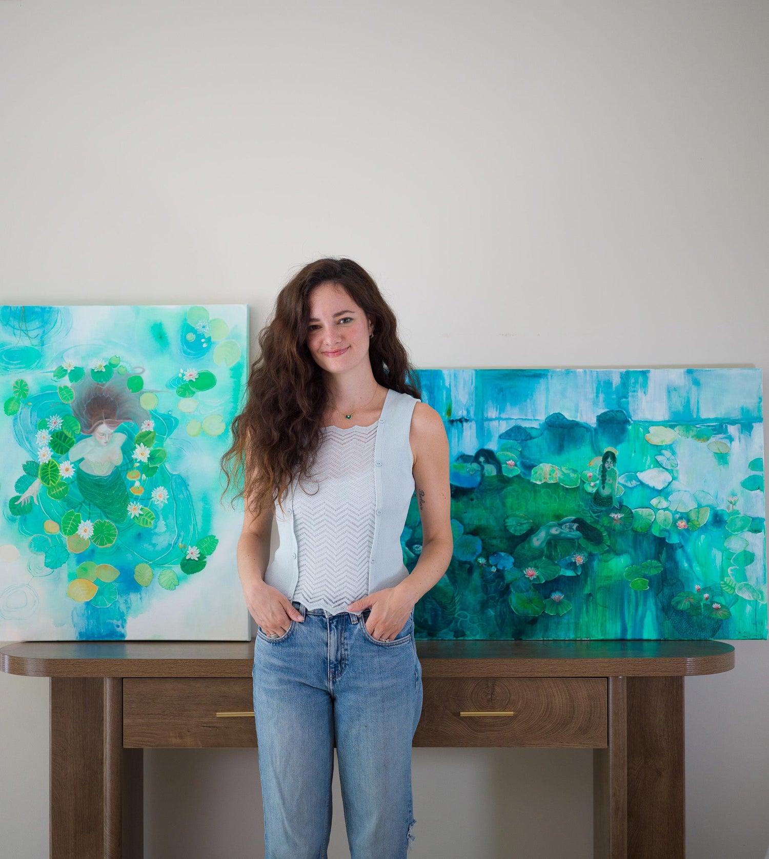 Two large contemporary mermaid paintings in shades of blue, green, and white